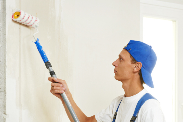 Residential Painter with roller and hat on